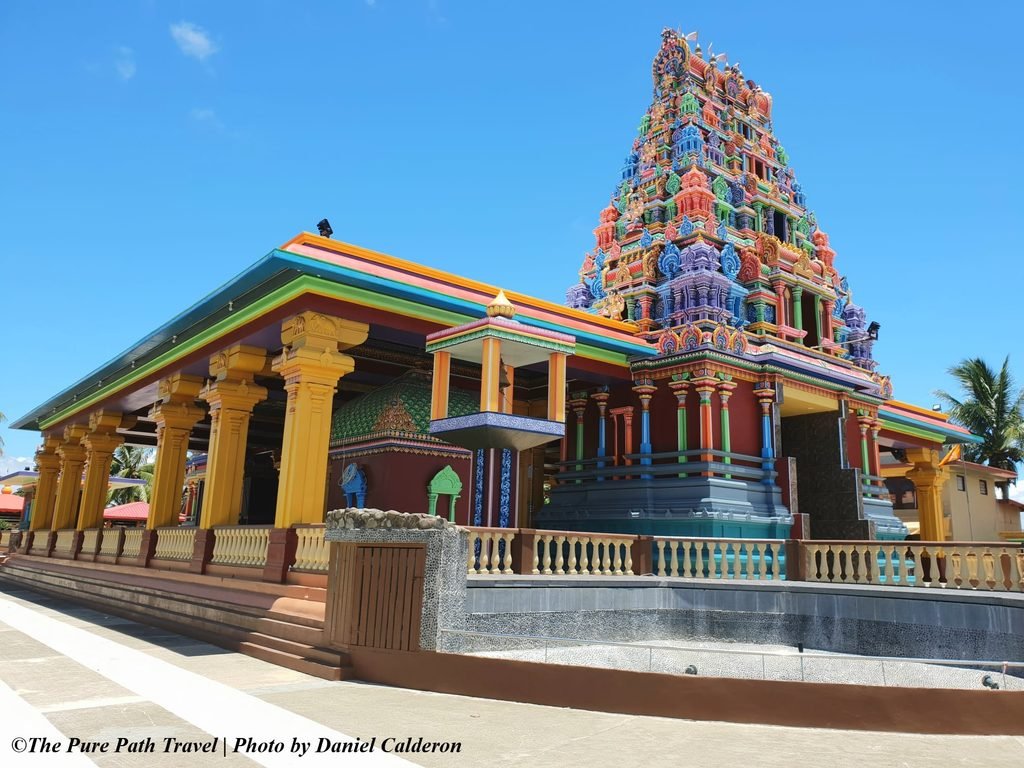 The striking, intricate Dravidian architecture of the Sri Siva Subramaniya Temple in Nadi, Fiji, showcasing vibrant multi-coloured painted details against a clear sky.